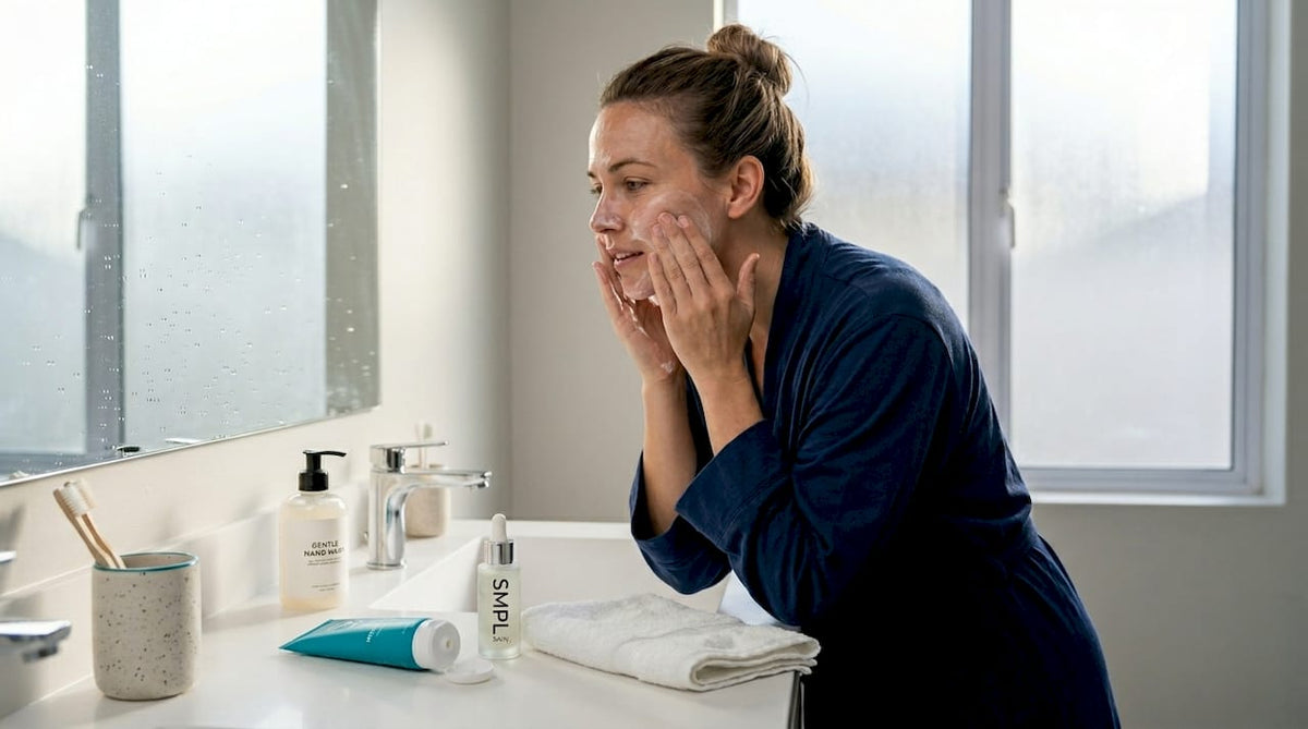 Woman preparing skin for makeup in bathroom
